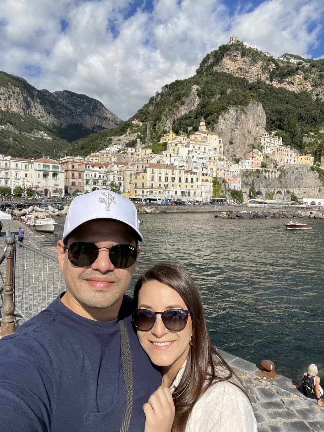 Adriana and Yair above a town stacked on the cliffs of the Amalfi Coast.