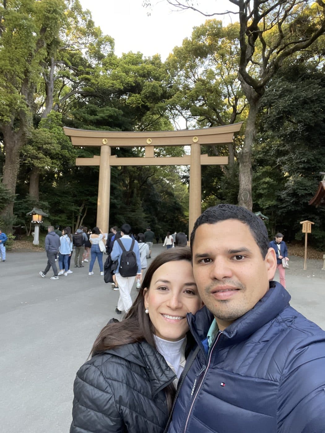 Adriana and Yair in front of a great wooden torii gate in a Tokyo park.
